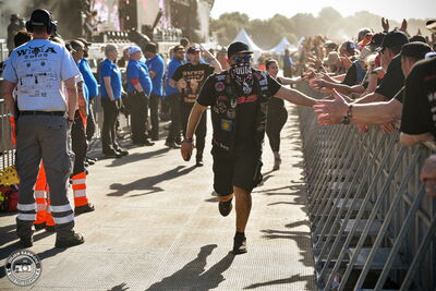Fans rushing through the pit after crowd surfing at Airbourne's Wacken Open Air 2026 show.
