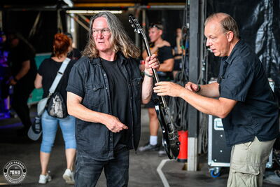 Thomas Jensen picking up his guitar during Skyline's soundcheck at Wacken Open Air 2026.