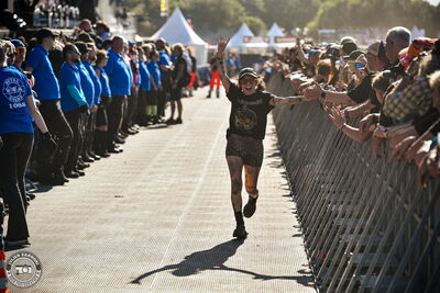 Fans running through the pit after crowd surfing during Airbourne's set at Wacken Open Air 2026.